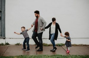 A family is having fun outside the house