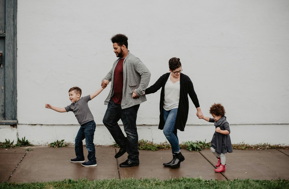 A family is having fun outside the house
